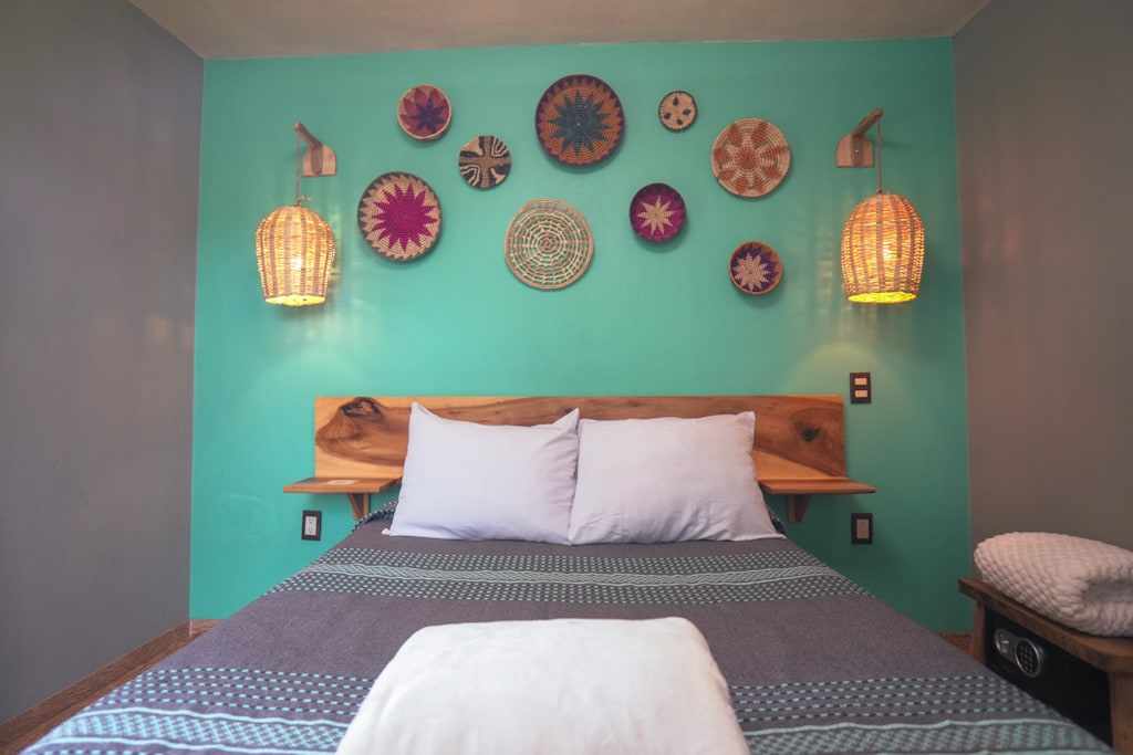 Agave bedroom with woven baskets on a turquoise wall