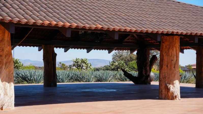Ambu Terrace, a covered terrace with wooden pillars facing the agave fields