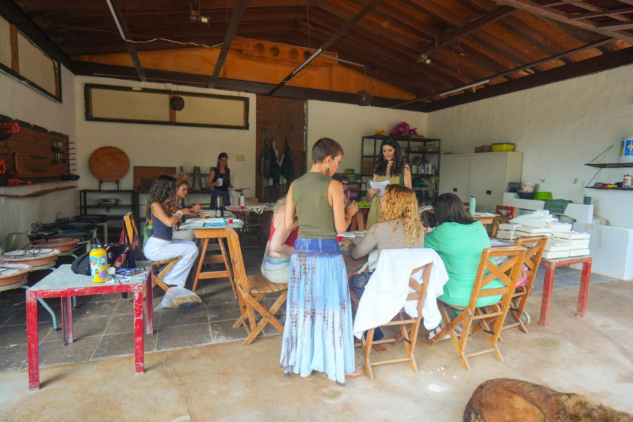 Guests painting at colourful tables in the art workshop