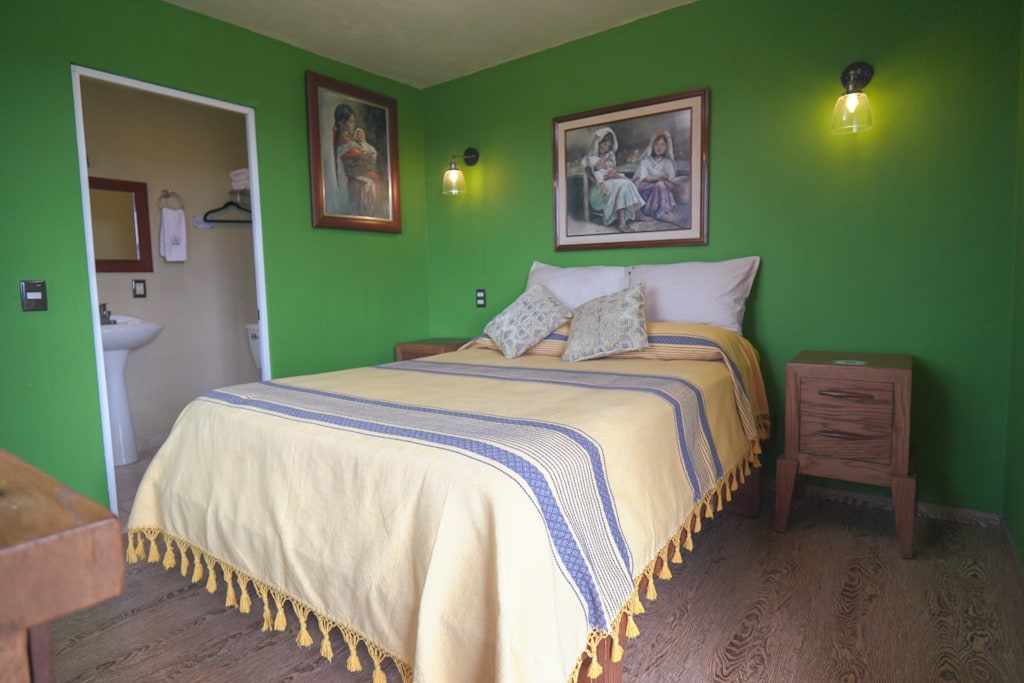 Maguey, a green room with a double bed and a private bathroom