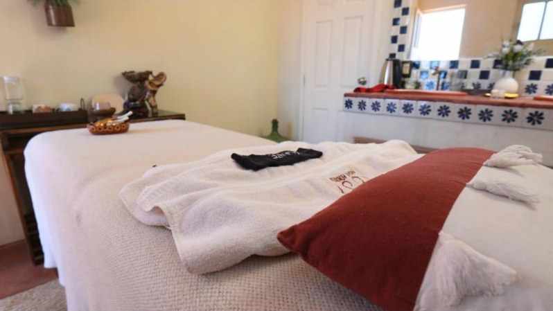 A massage table made up with white towels in the spa