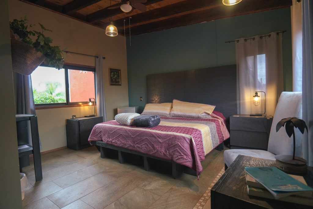 Oeste bedroom with a purple bed and a large window