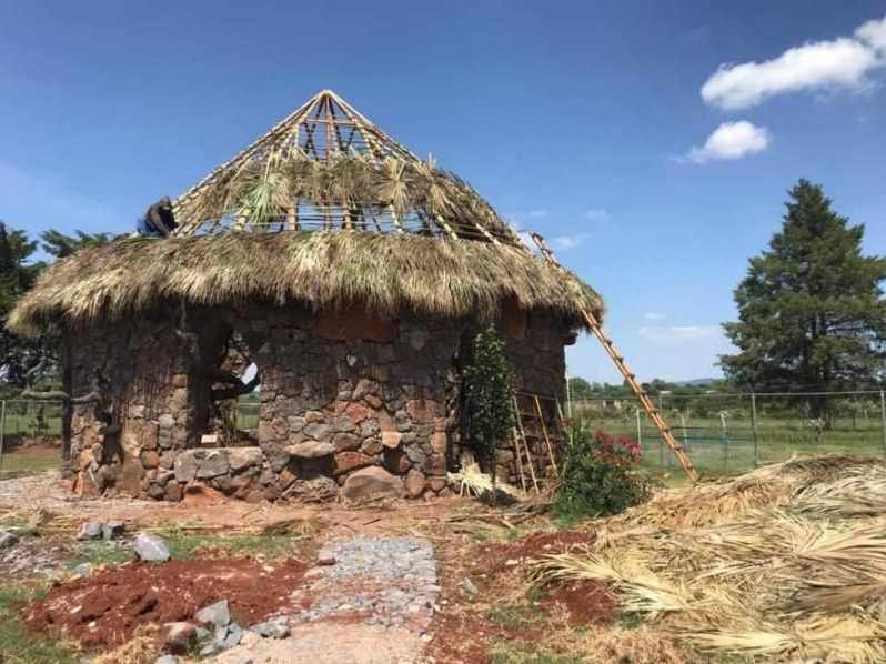 The Osho Hut under construction, its palm roof half laid