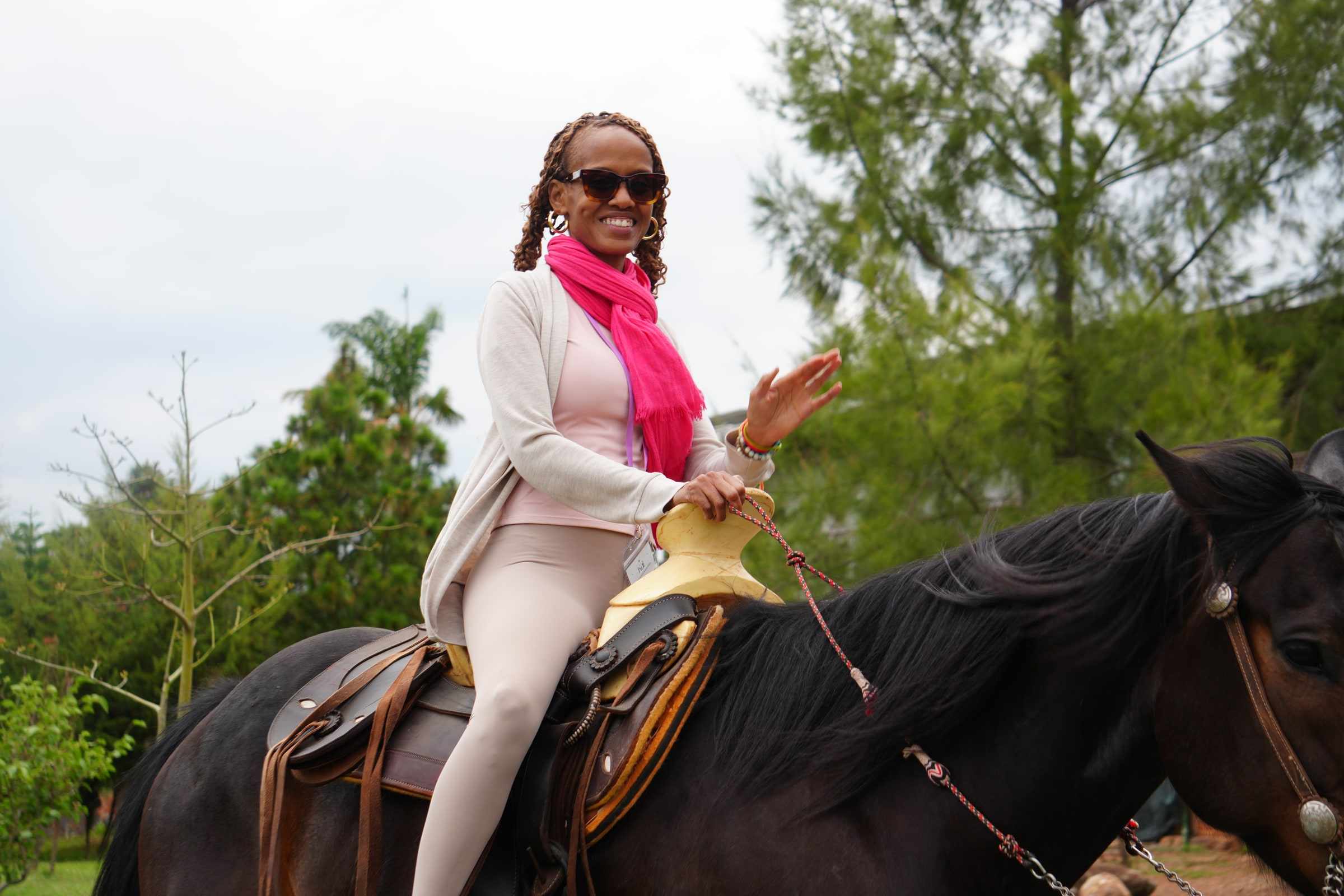 A smiling rider on a dark horse