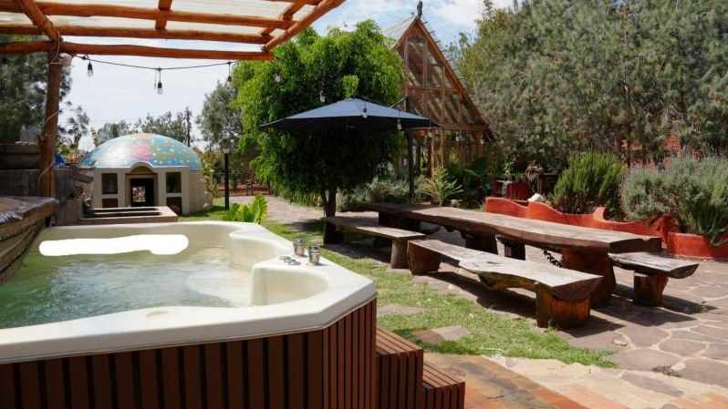 Sammasati, with a jacuzzi and long wooden tables under string lights
